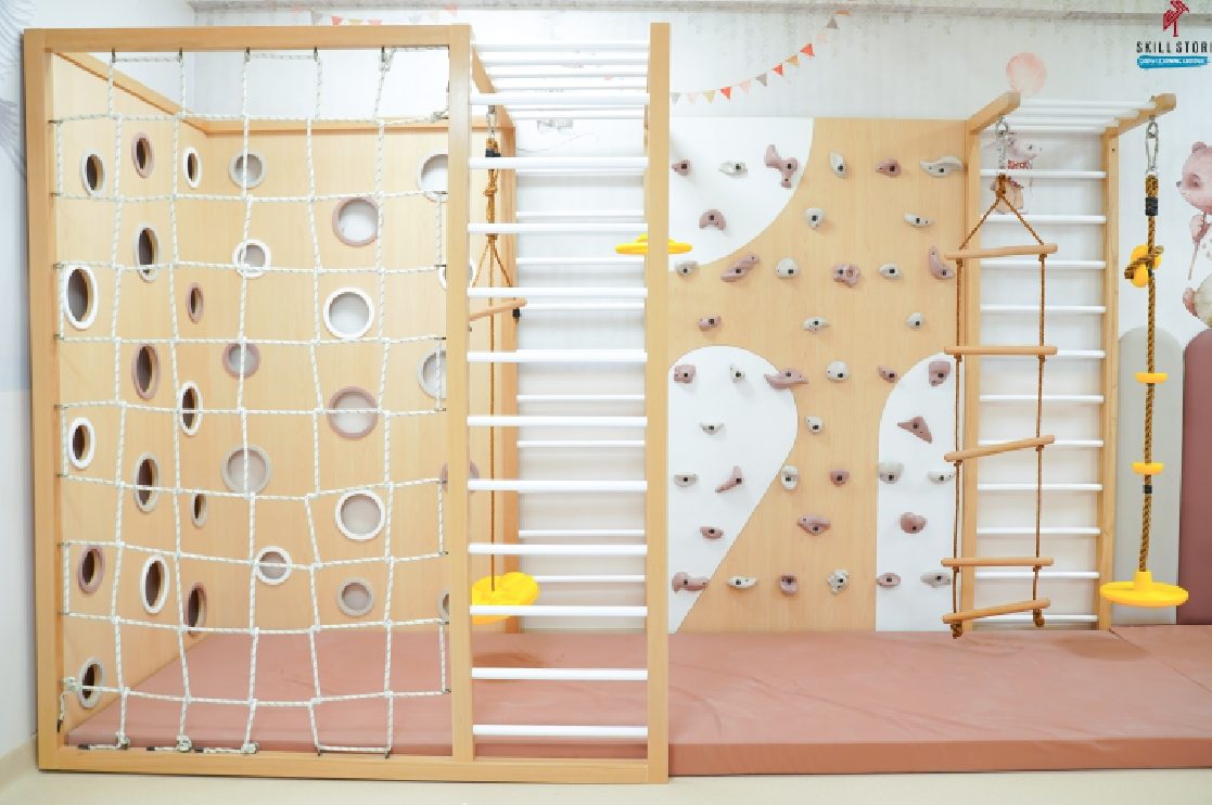 An indoor climbing and adventure wall at Skill Stork ELC