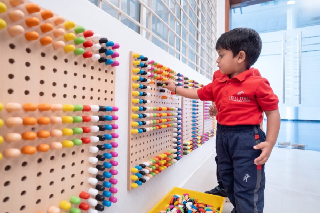 A child using a counting wall at Skill Stork ELC