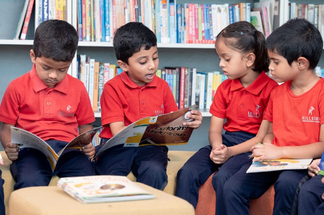 Children reading together in the library at Skill Stork ELC