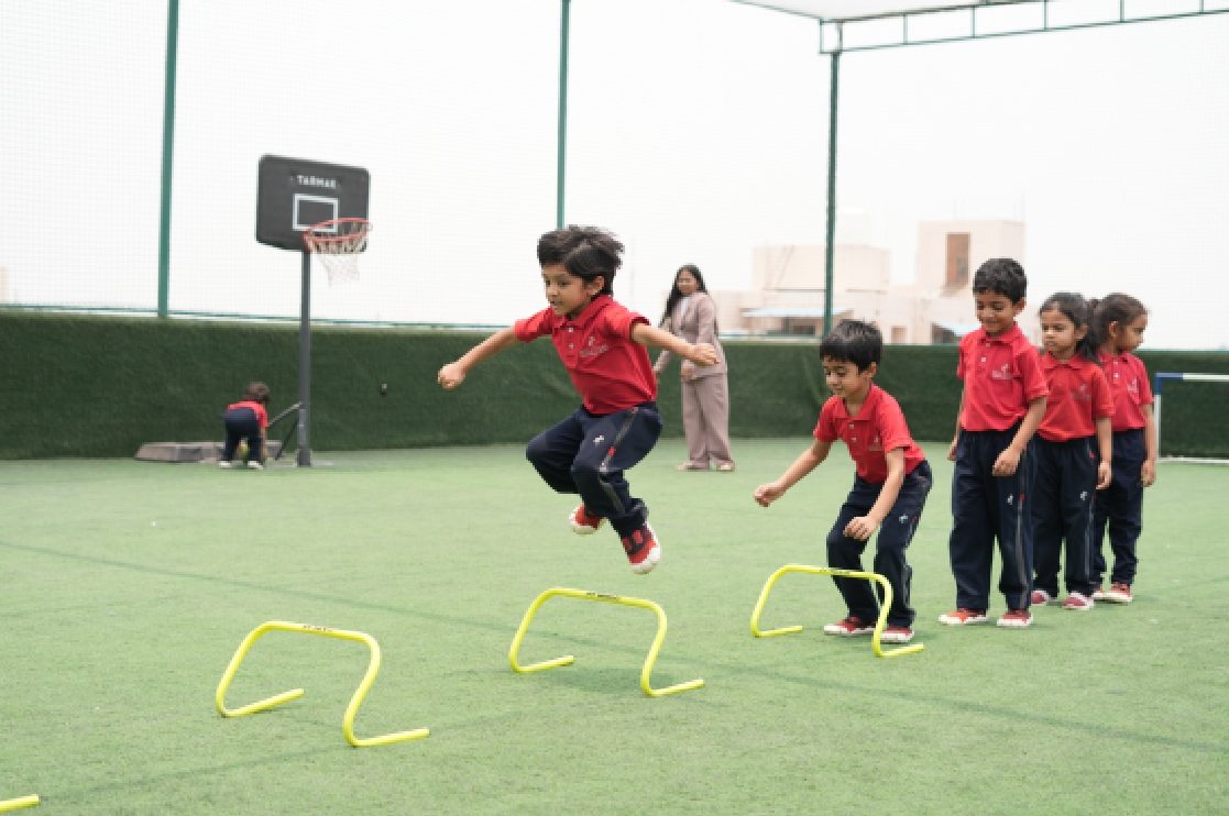 Children on an outdoor sports field at Skill Stork ELC